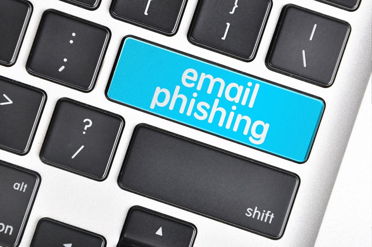 The computer keyboard button written word email phishing .